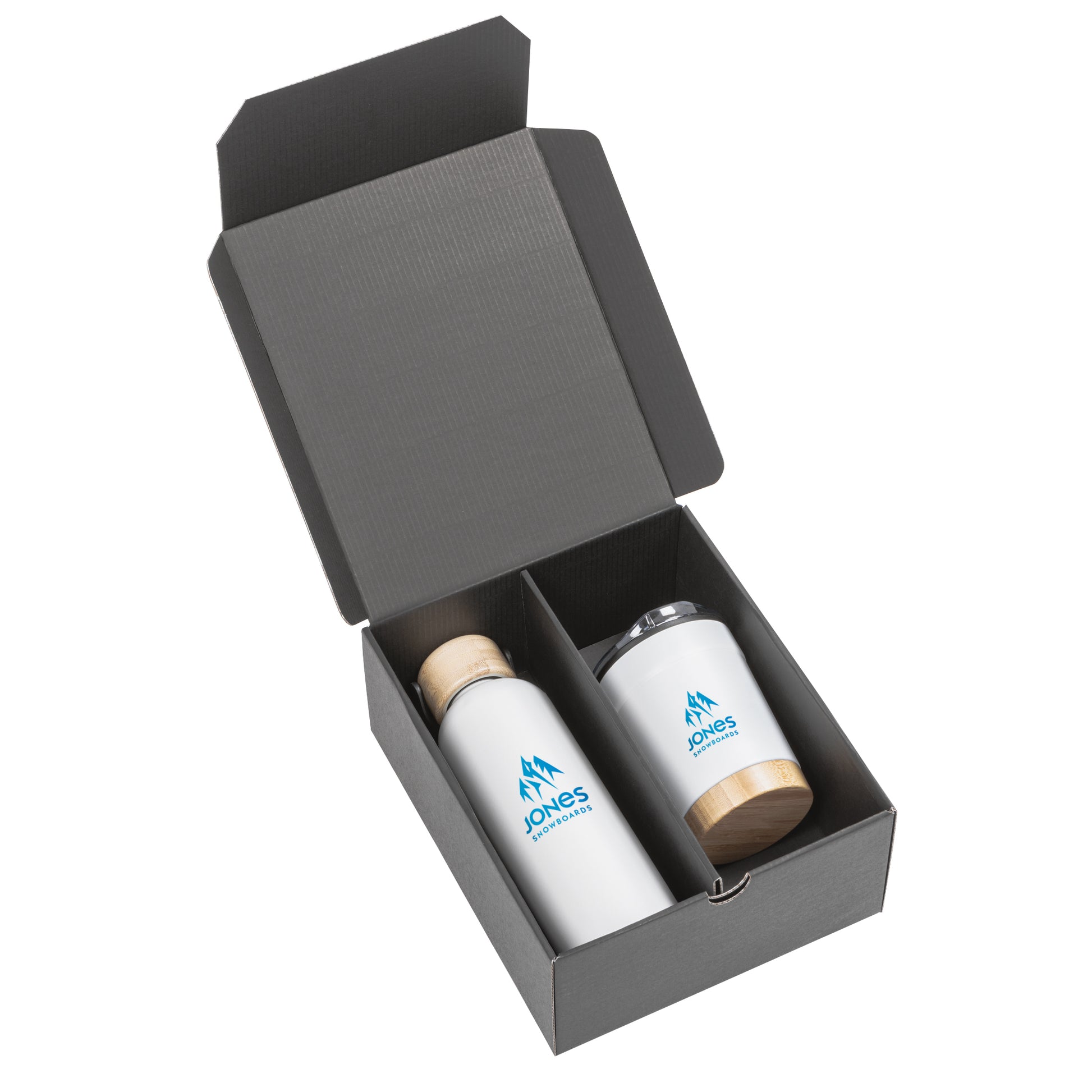Black gift box containing a matte white stainless steel bottle with a bamboo lid and a matching tumbler with bamboo base and clear lid, both branded with the Jones Snowboards logo