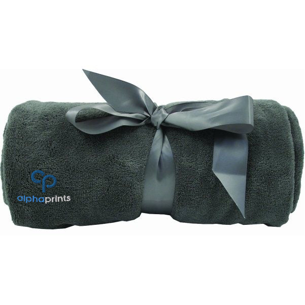 Rolled grey plush blanket tied with a satin ribbon and embroidered with the 'alphaprints' logo.