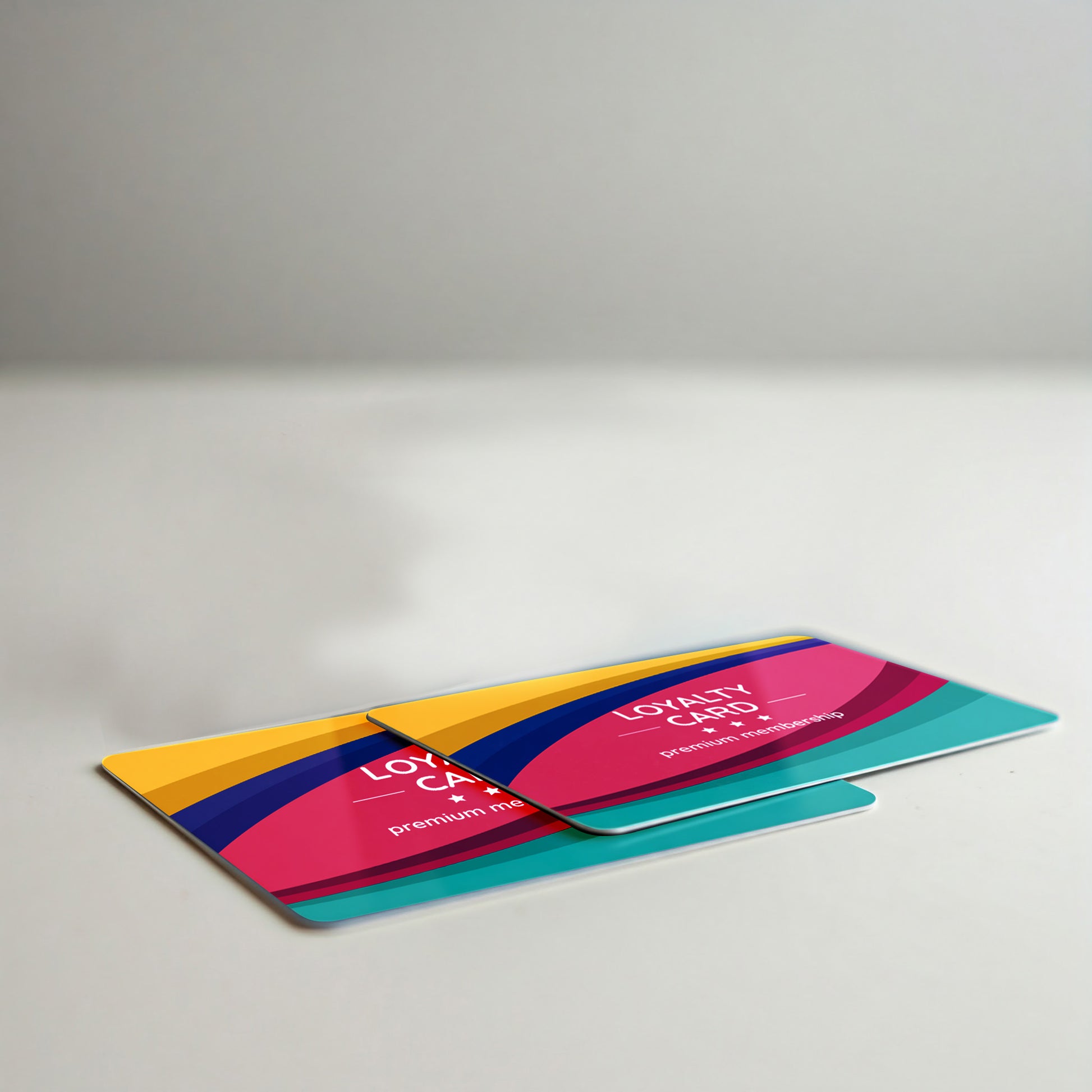 Colorful loyalty cards with a bold, modern design featuring curved stripes in pink, yellow, blue, and teal, labeled “LOYALTY CARD +ID” and “premium membership.”