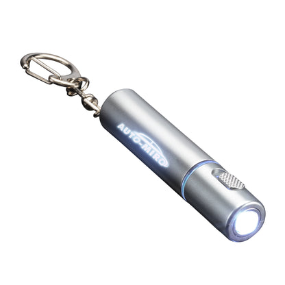 Sunray LED Keychain flashlight in metallic silver finish, featuring a bright white LED light, textured silver push-button, and glowing custom 'AUTO MIRO' logo illuminated in white; includes metal keyring attachment