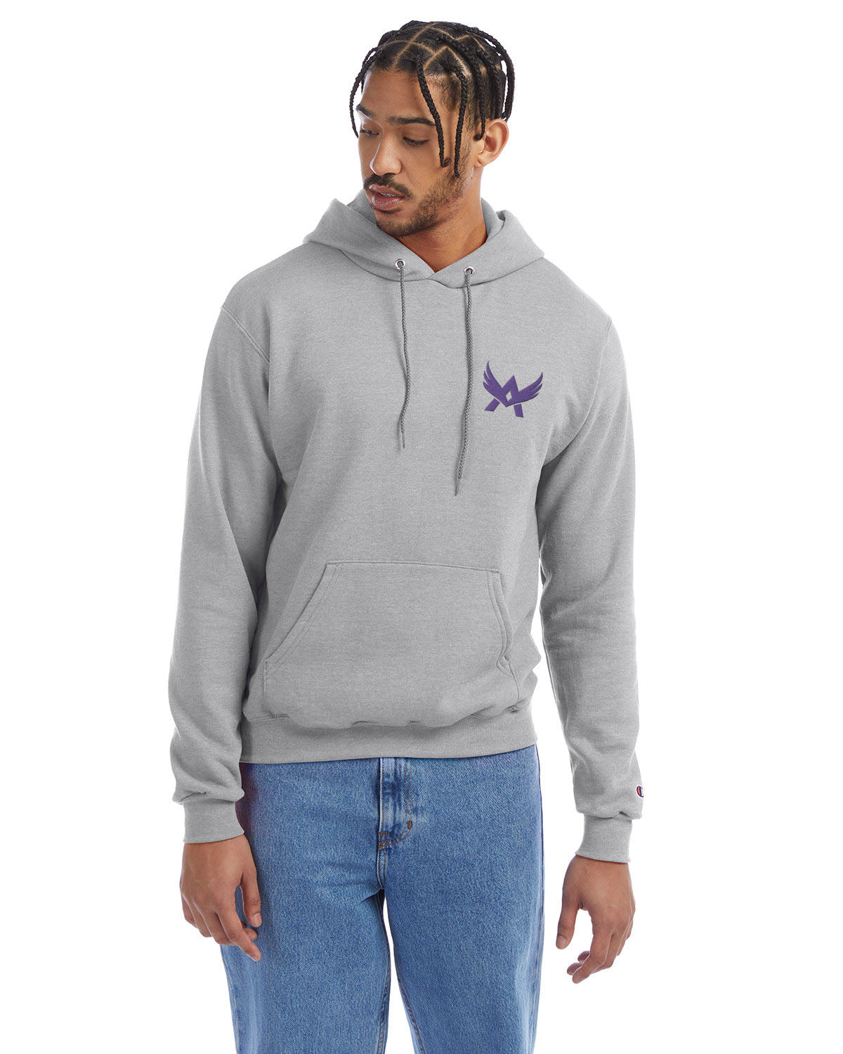 Model wearing a light grey Champion hoodie with a front kangaroo pocket and a purple abstract winged logo on the left chest, paired with blue jeans.