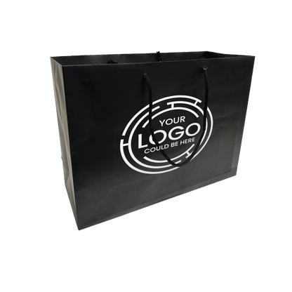 Black paper shopping bag with black rope handles and a circular white "YOUR LOGO COULD BE HERE" design printed on the front.