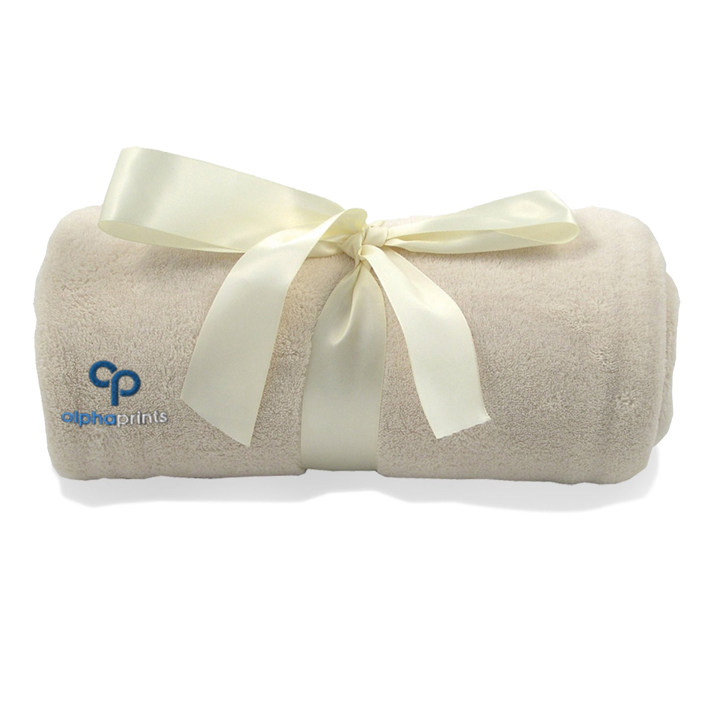 Rolled vanilla beige plush blanket tied with a satin ribbon and embroidered with the 'alphaprints' logo.
