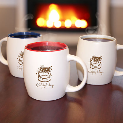Custom ceramic mugs with colored interiors and Cafe by Stage logo.