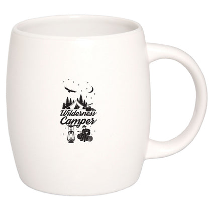 White ceramic mug with "Wilderness Camper" design featuring trees, tent, and camping icons.