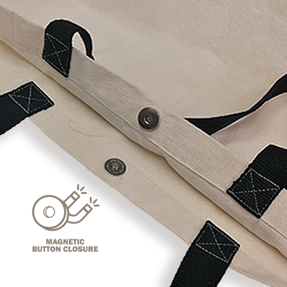 Close-up of magnetic button closure on canvas tote bag with reinforced black handles.