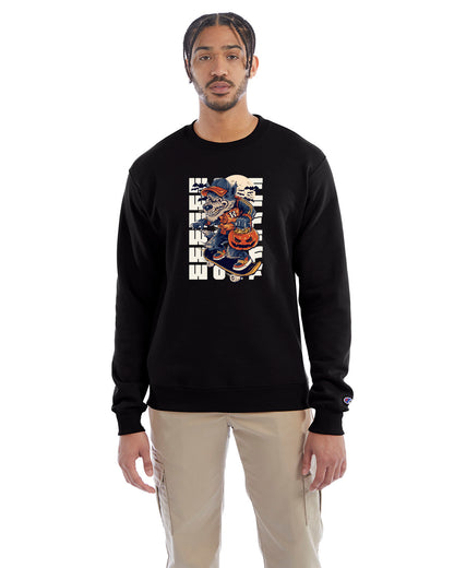 Black crewneck sweatshirt with a Halloween-themed graphic of a cartoon werewolf skateboarding with a pumpkin basket, worn by a model in beige pants.