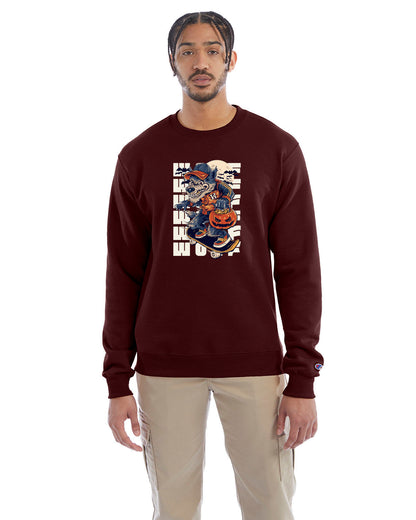 Maroon crewneck sweatshirt with a Halloween-themed graphic of a cartoon werewolf skateboarding with a pumpkin basket, worn by a model in beige pants.