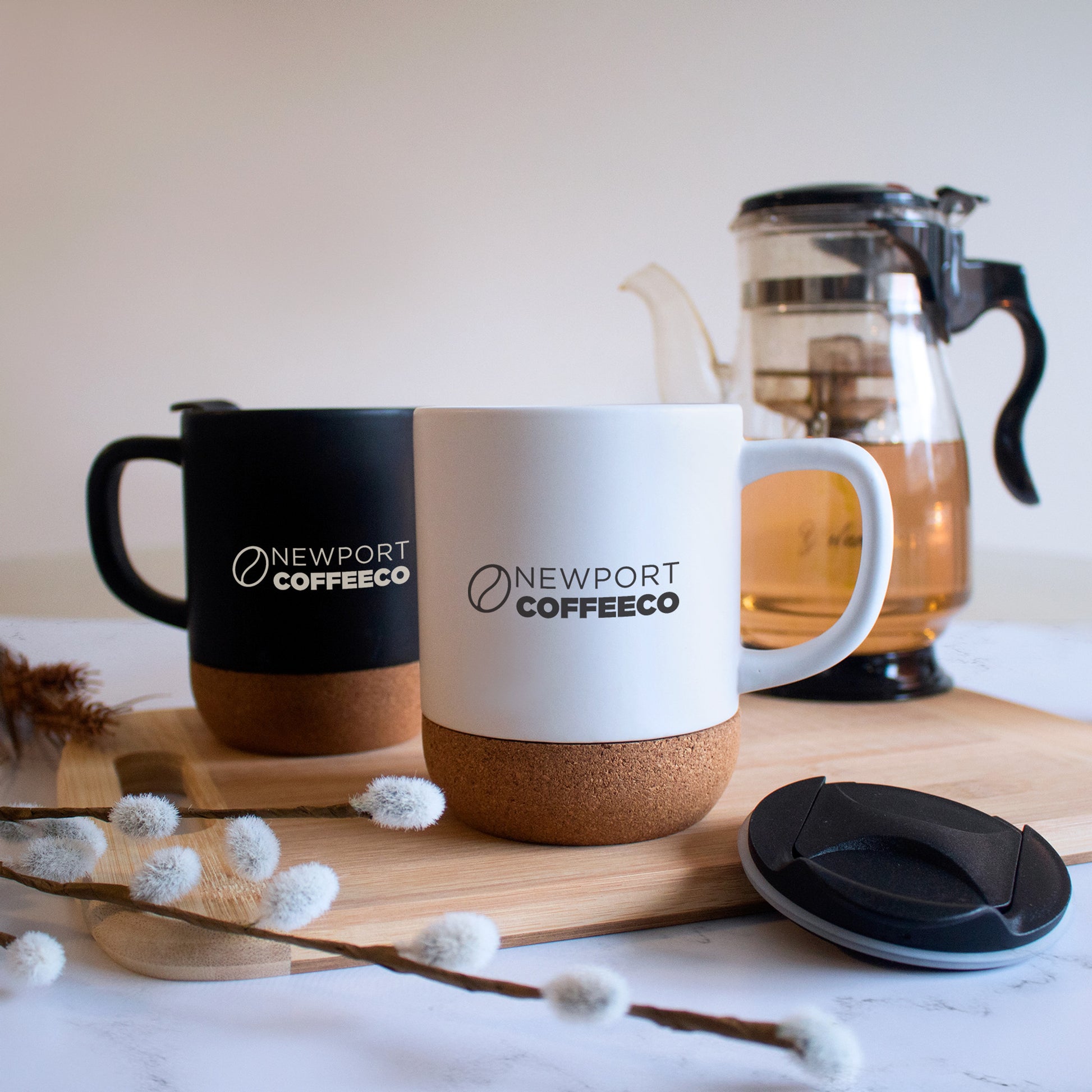 Sleek matte ceramic mugs with eco-friendly cork bottoms and a prominent logo display.