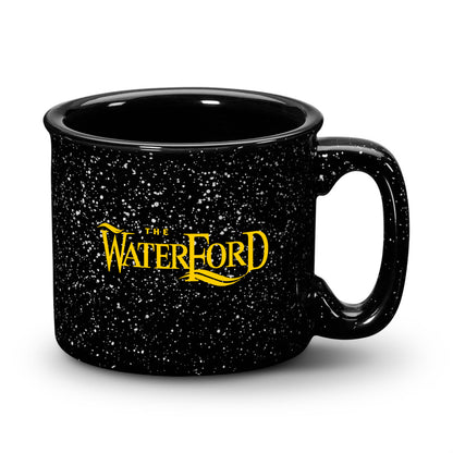 Black ceramic campfire mug with a speckled finish, black rim, and “The Waterford” logo in bold print.