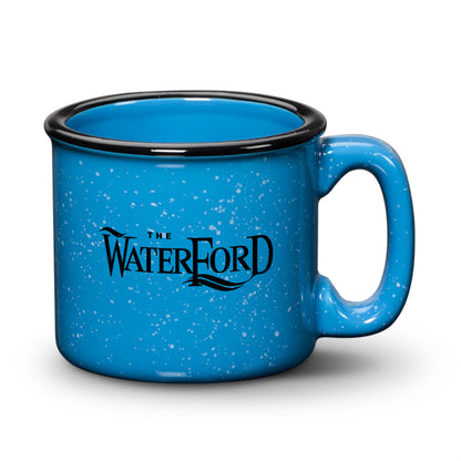Hawaii blue ceramic campfire mug with a speckled finish, black rim, and “The Waterford” logo in bold print.
