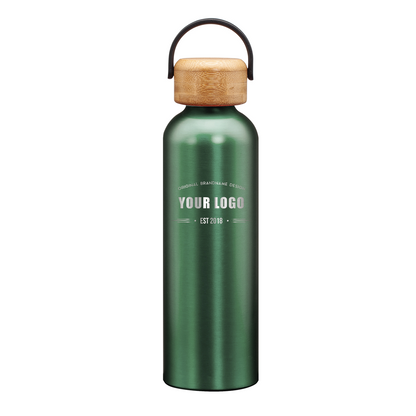 Matte green stainless steel water bottle with bamboo lid and handle, featuring engraved custom logo on front.