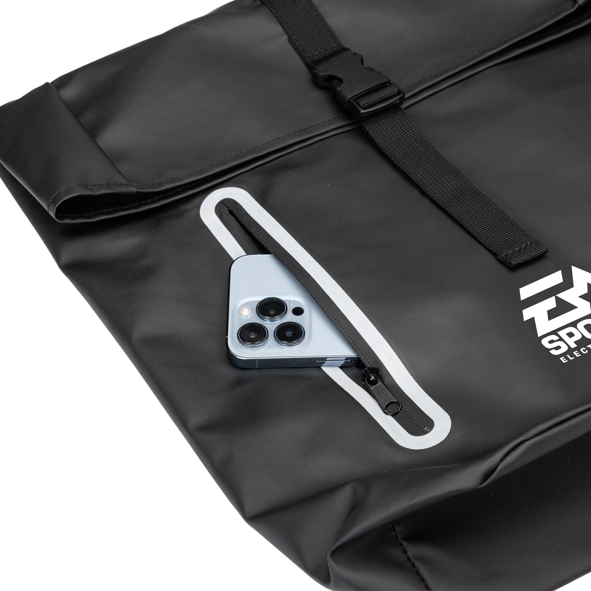 Close-up of the Hazen backpack's front zipper pocket with a smartphone partially inserted, highlighting easy-access storage feature.