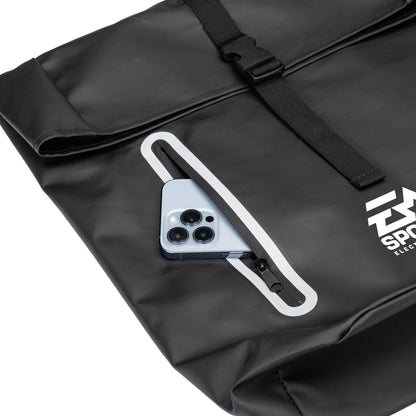 Close-up of the Hazen backpack's front zipper pocket with a smartphone partially inserted, highlighting easy-access storage feature.