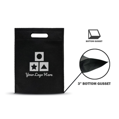 Black non-woven tote bag with die-cut handle and white geometric icon print, featuring a bottom gusset detail magnified to show stitching and material texture