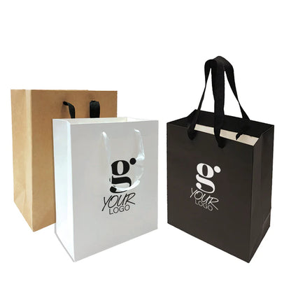 Custom logo gift bags in kraft, white, and black finishes with matching rope handles.