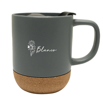 Matte grey ceramic mug with a natural cork base and black lid, featuring a delicate white logo