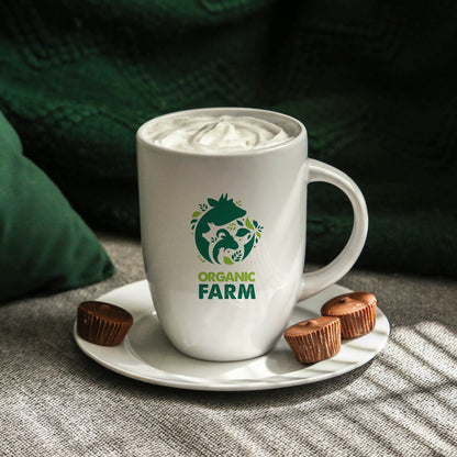 White ceramic mug with a tall profile, featuring a green logo on the front