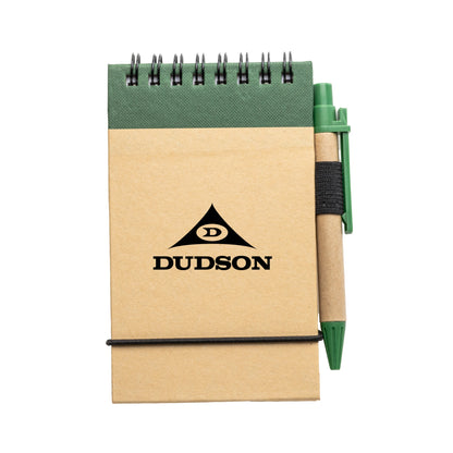 Small kraft paper spiral notepad with green elastic closure and matching eco-friendly pen in holder, featuring a logo on the front cover.