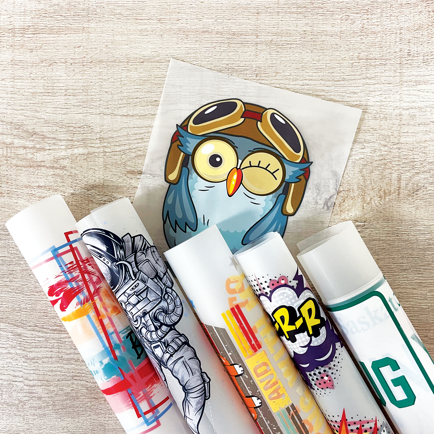 A collection of colorful Custom DTF Heat Transfer Sheets with playful designs