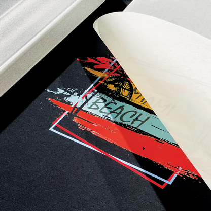 A close-up of a Miami Beach-themed Custom DTF Heat Transfer Sheet being peeled off fabric